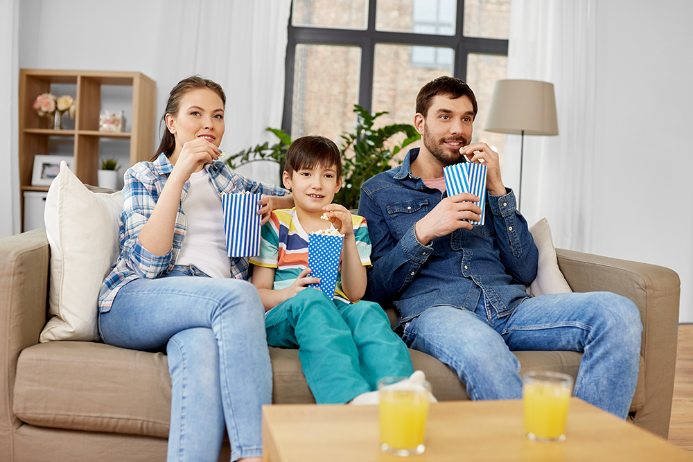 happy-family-with-popcorn-watching-tv-home